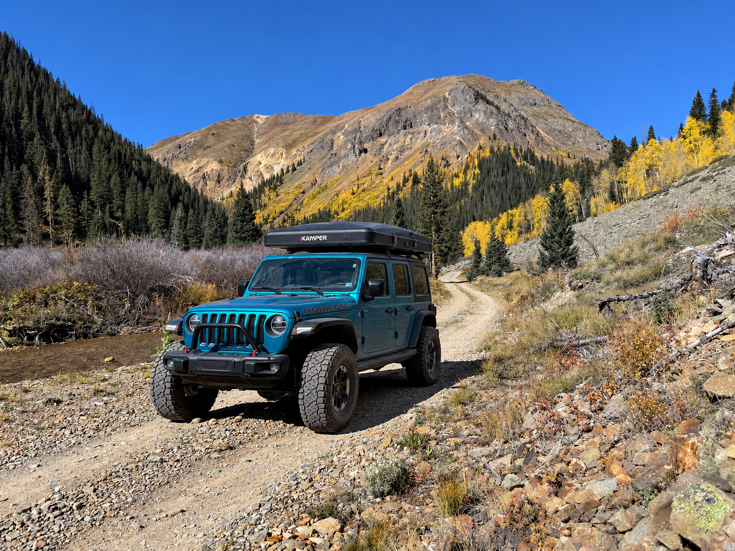 Jeep Wrangler rental in Colorado - Summit Rubicon with iKamper rooftop tent on a mountain trail